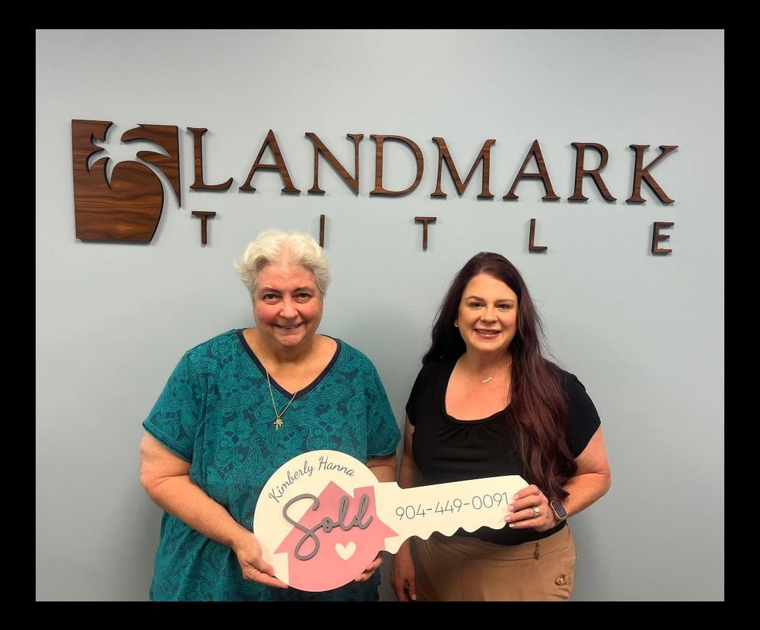 Kimberly Hanna with a client at the closing table at Landmark Title